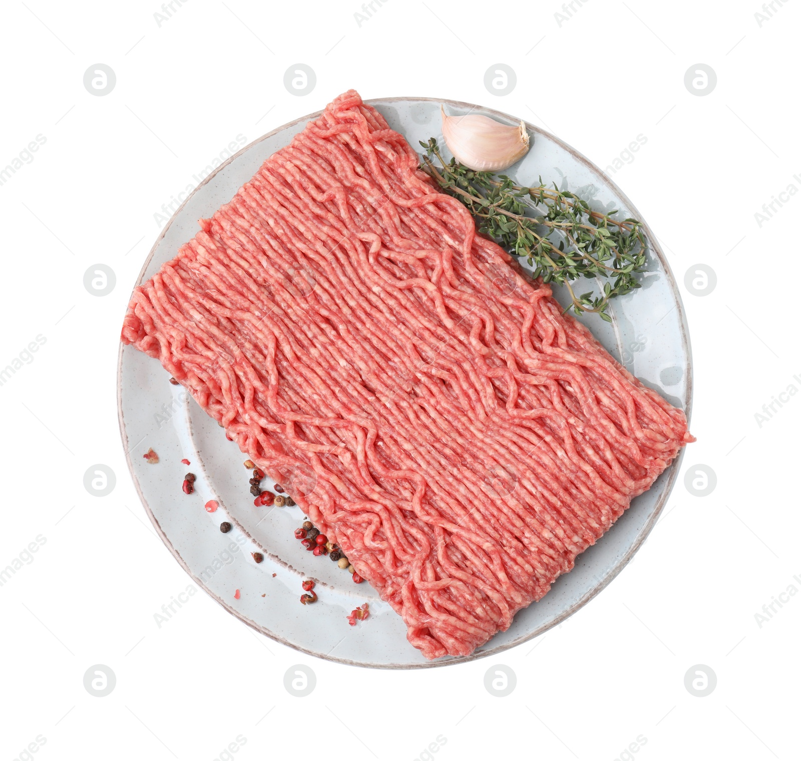 Photo of Fresh raw ground meat, peppercorns, garlic and thyme isolated on white, top view