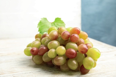 Photo of Fresh ripe juicy grapes on table. Wine ingredient
