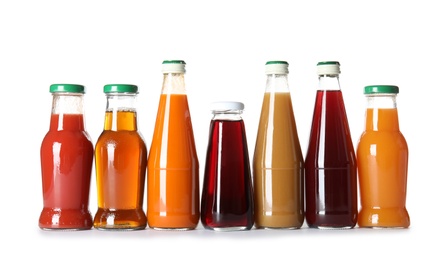 Bottles with different drinks on white background