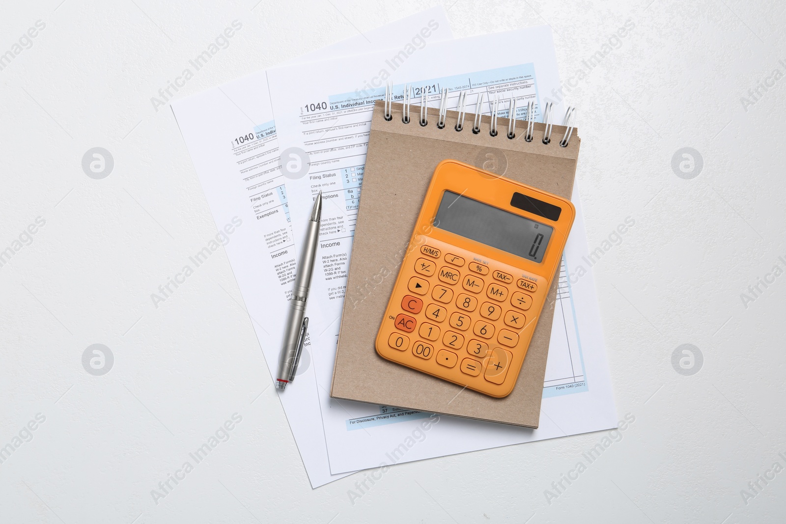 Photo of Calculator, documents and stationery on white table, flat lay. Tax accounting