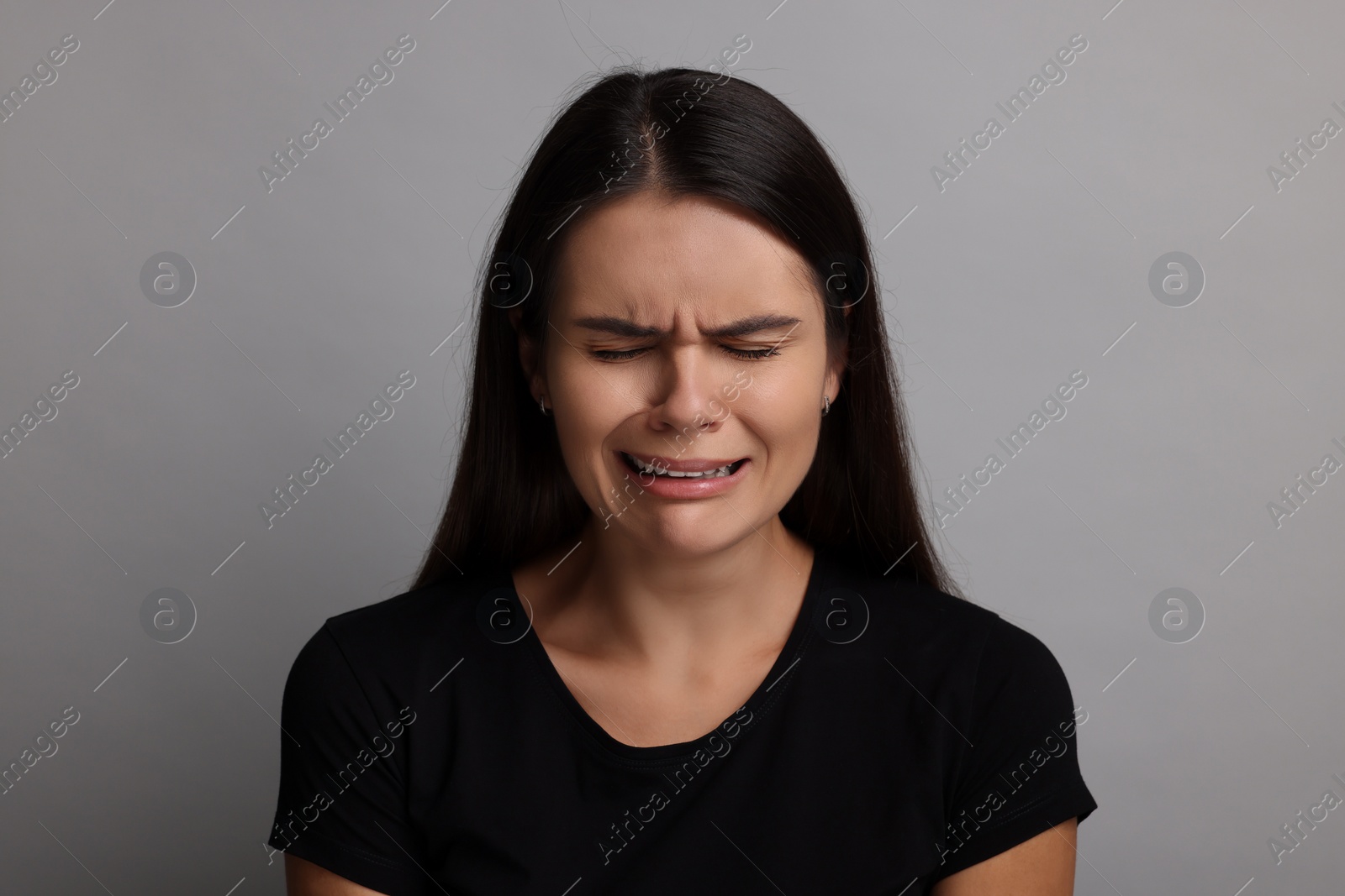 Photo of Personality concept. Emotional woman on grey background