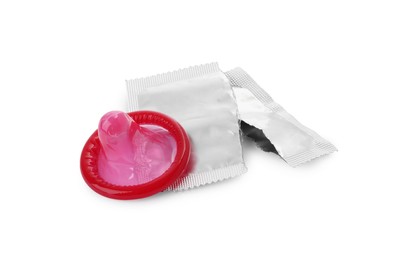 Unpacked condom and torn package on white background. Safe sex