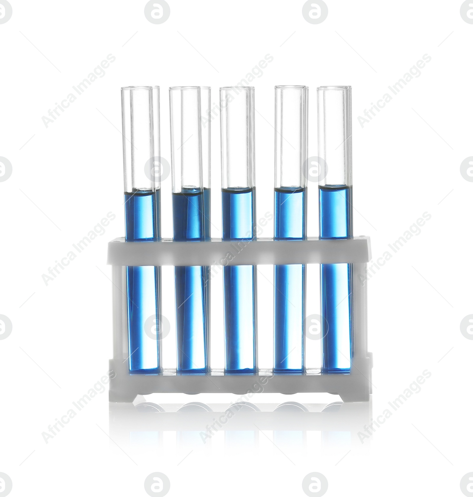 Photo of Test tubes with liquid samples in rack on white background. Chemistry glassware