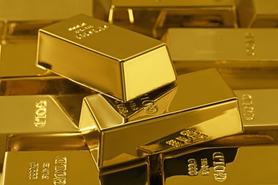 Many shiny gold bars as background, closeup