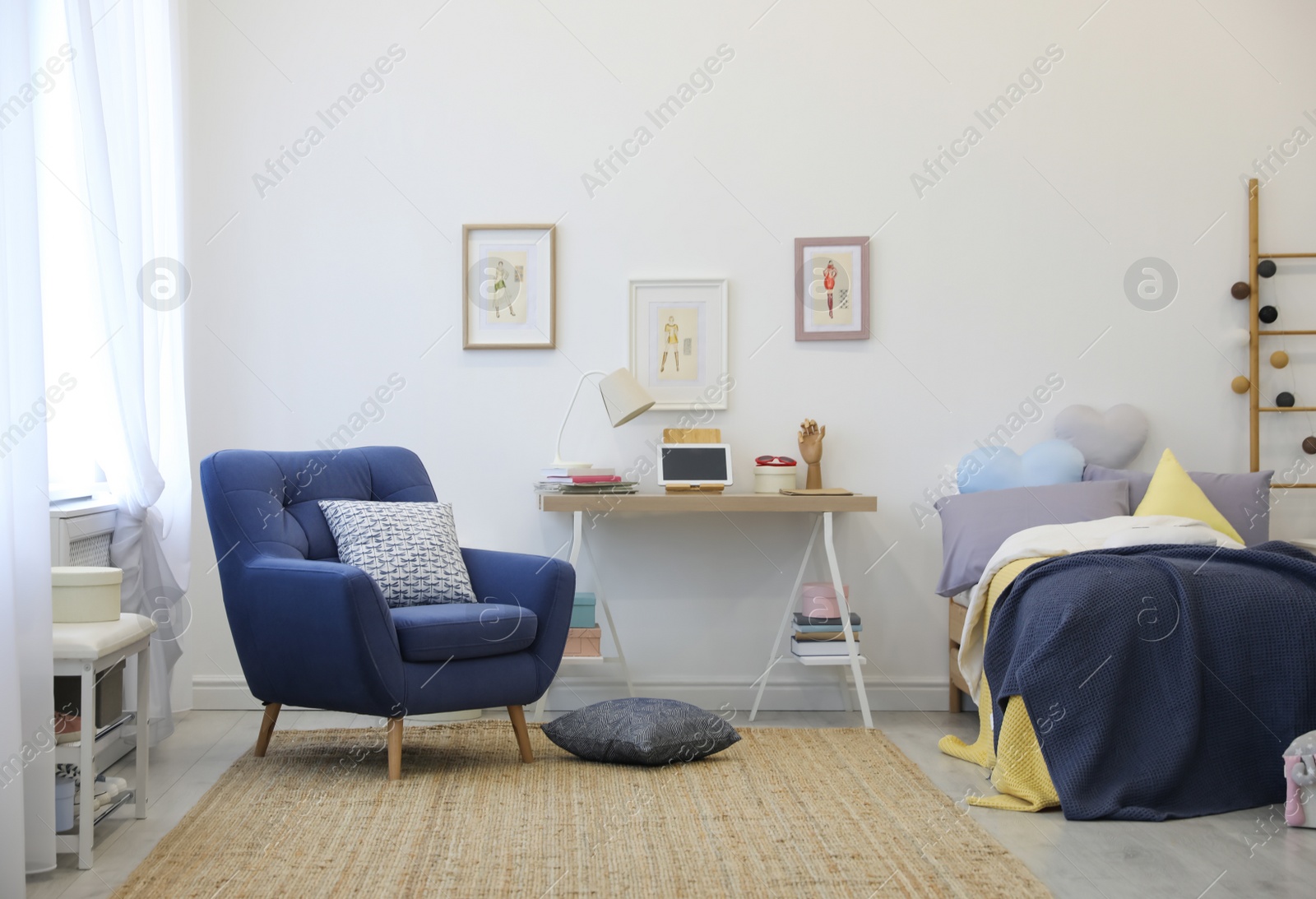Photo of Modern teenager's room interior with bed and armchair