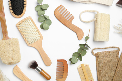 Photo of Frame of hair combs and brushes on white background, top view. Space for text