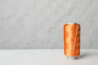 Photo of Color sewing thread with needle on table