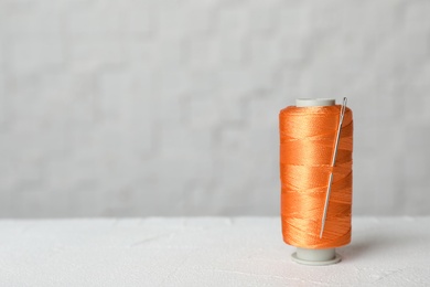 Color sewing thread with needle on table