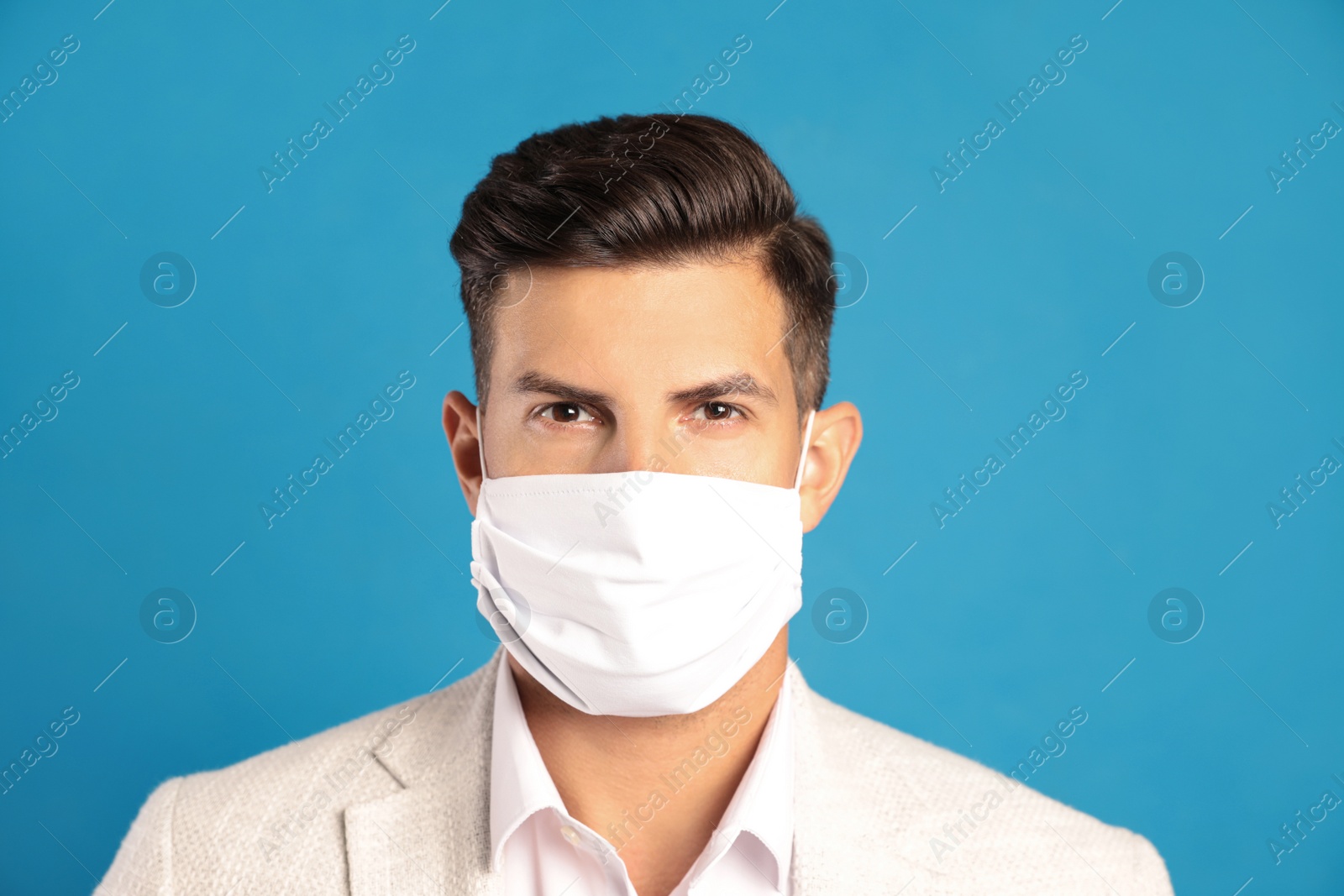 Photo of Man in protective face mask on blue background