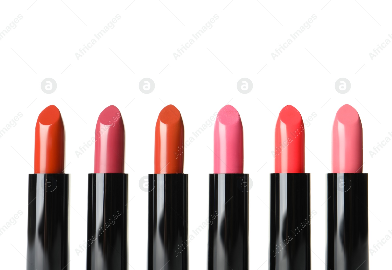 Photo of Different lipsticks on white background. Cosmetic product