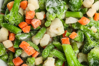 Photo of Different frozen vegetables as background, top view