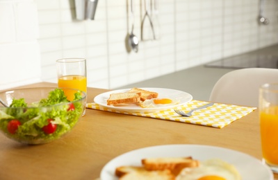 Tasty breakfast served on table in kitchen