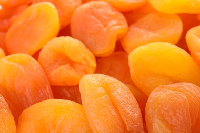 Photo of Tasty apricots as background, closeup. Dried fruit as healthy food