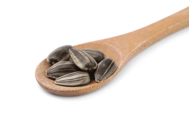 Photo of Raw organic sunflower seeds in wooden spoon isolated on white