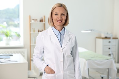 Portrait of happy dermatologist in modern clinic