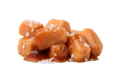 Photo of Yummy caramel candies and sea salt isolated on white