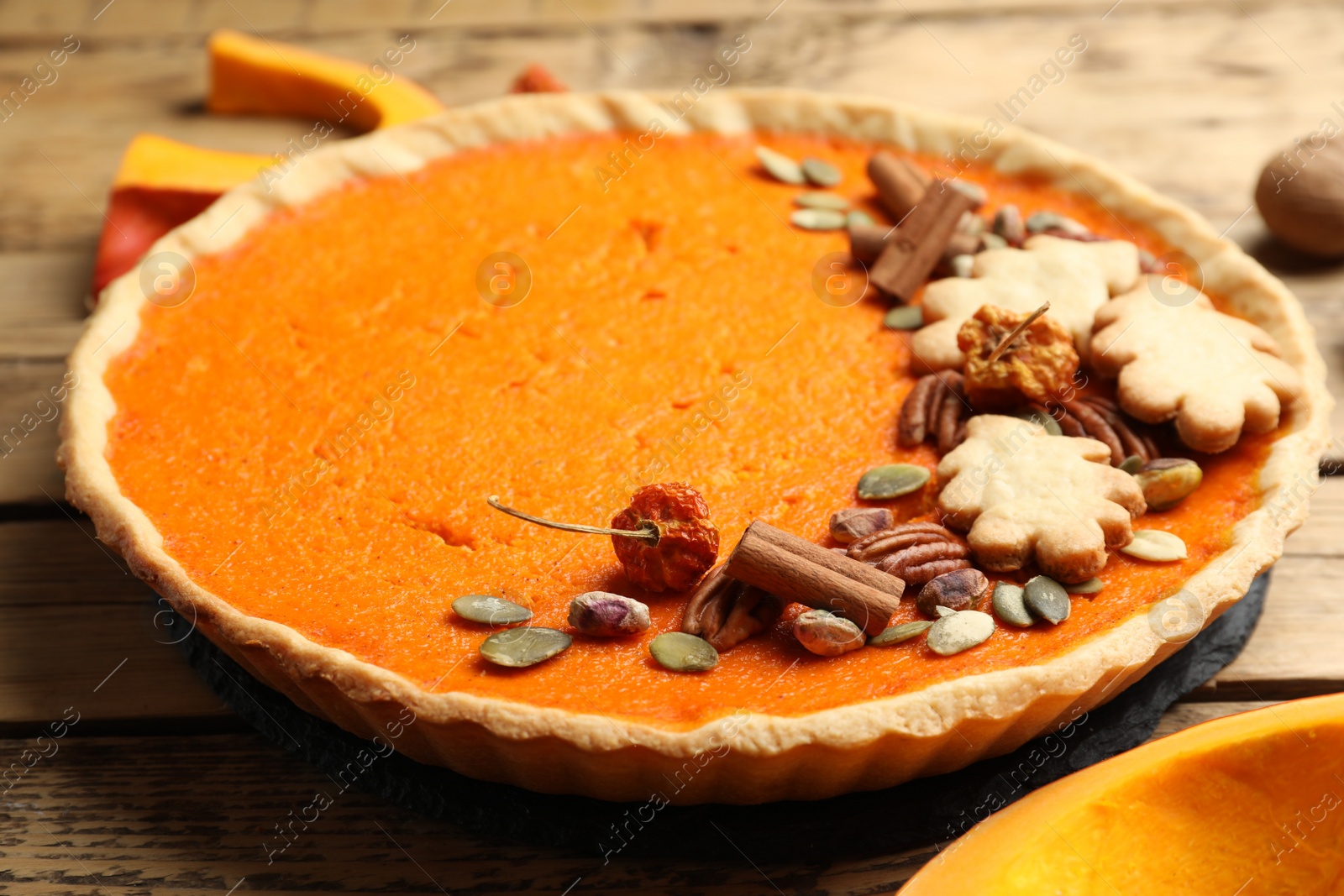 Photo of Delicious homemade pumpkin pie on wooden table