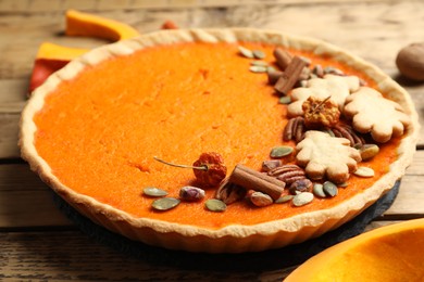 Delicious homemade pumpkin pie on wooden table