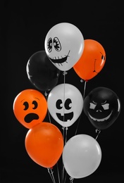 Photo of Color balloons for Halloween party on black background