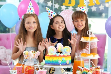 Happy children at birthday party in decorated room