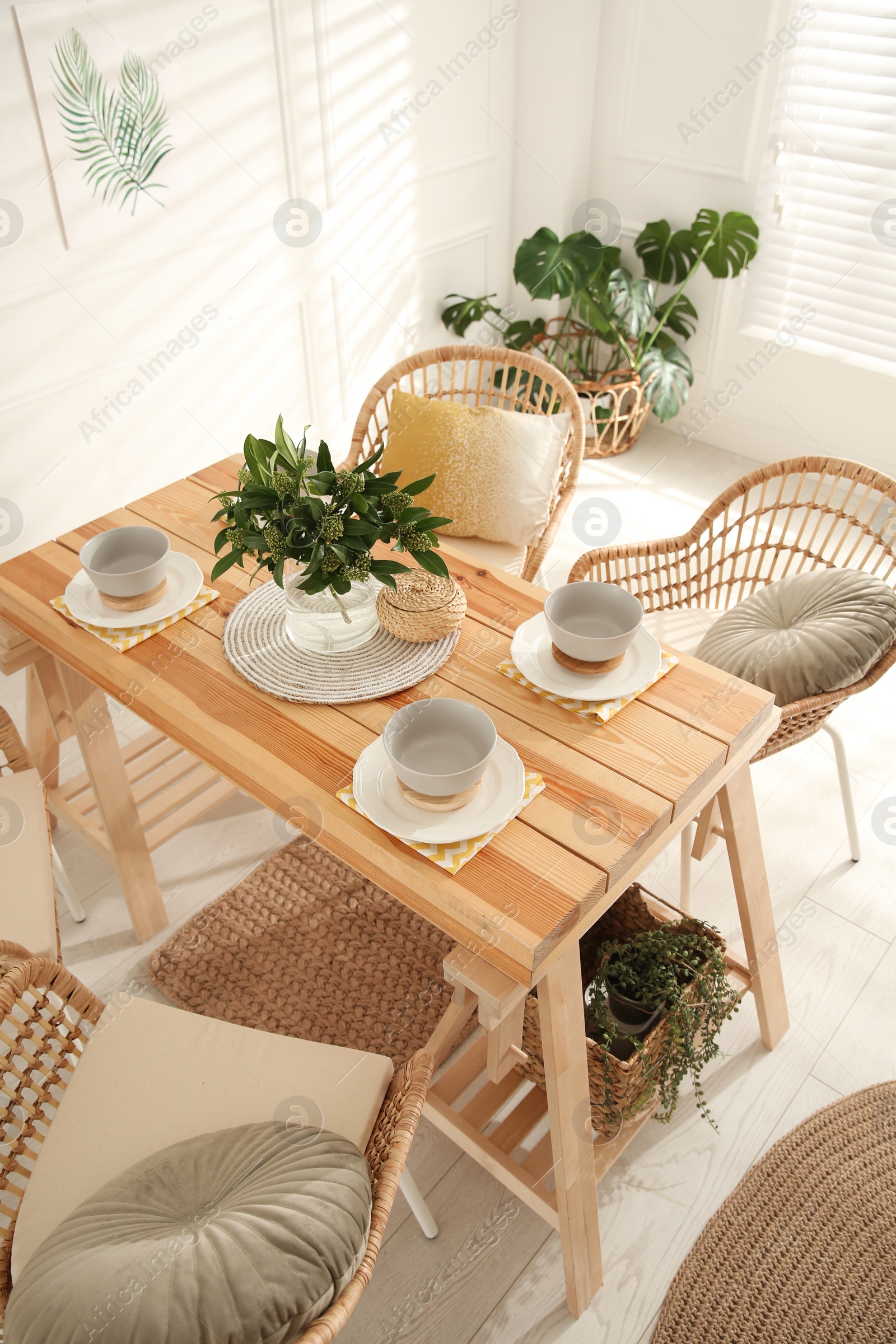 Photo of Stylish wooden dining table and chairs in room. Interior design