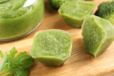 Photo of Frozen broccoli puree cubes on cutting board, closeup