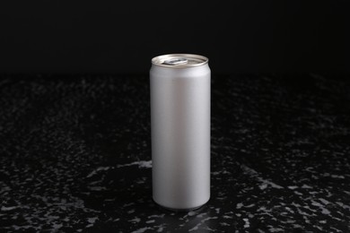 Energy drink in can on black textured table