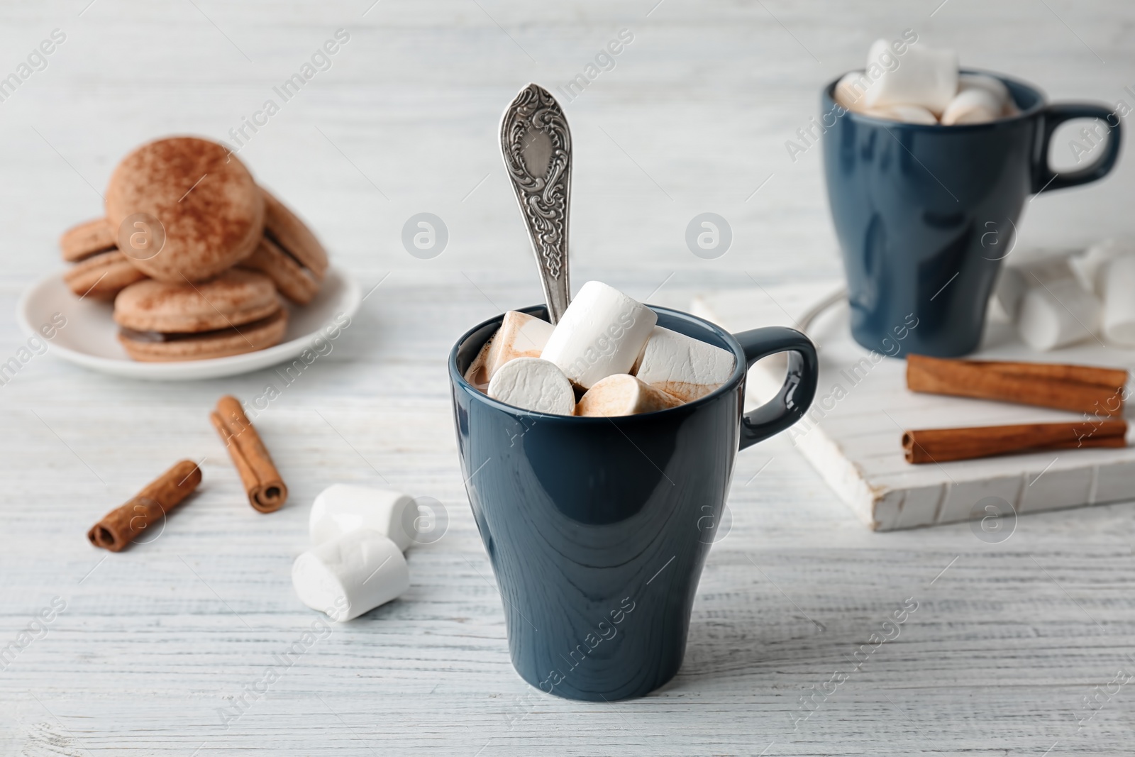 Photo of Cup with delicious hot cocoa drink and marshmallows on table