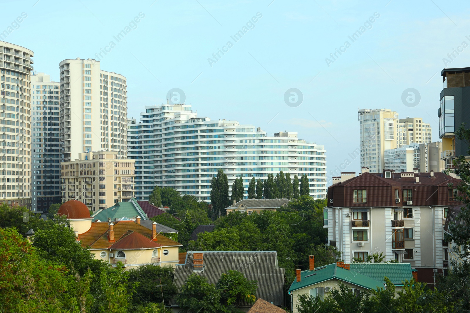 Photo of Beautiful cityscape with trees and different buildings on sunny day