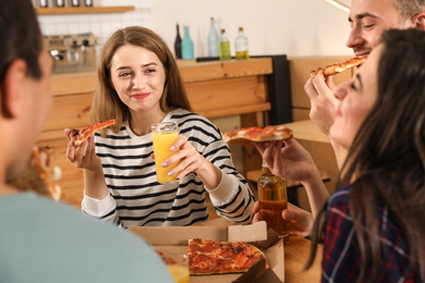 Photo of Group of friends having fun party with delicious pizza in cafe