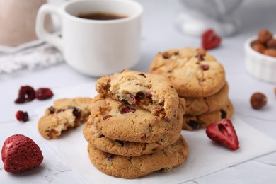 Photo of Cookies with freeze dried fruits and nuts on white marble table, closeup