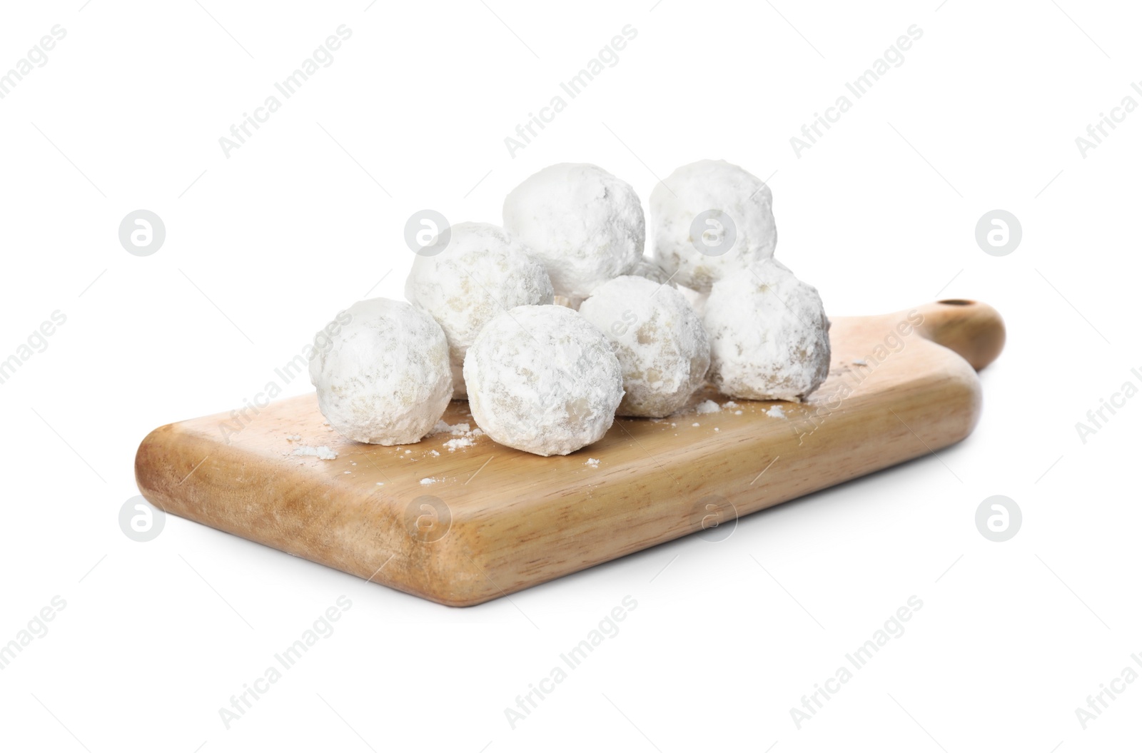 Photo of Wooden board with Christmas snowball cookies isolated on white