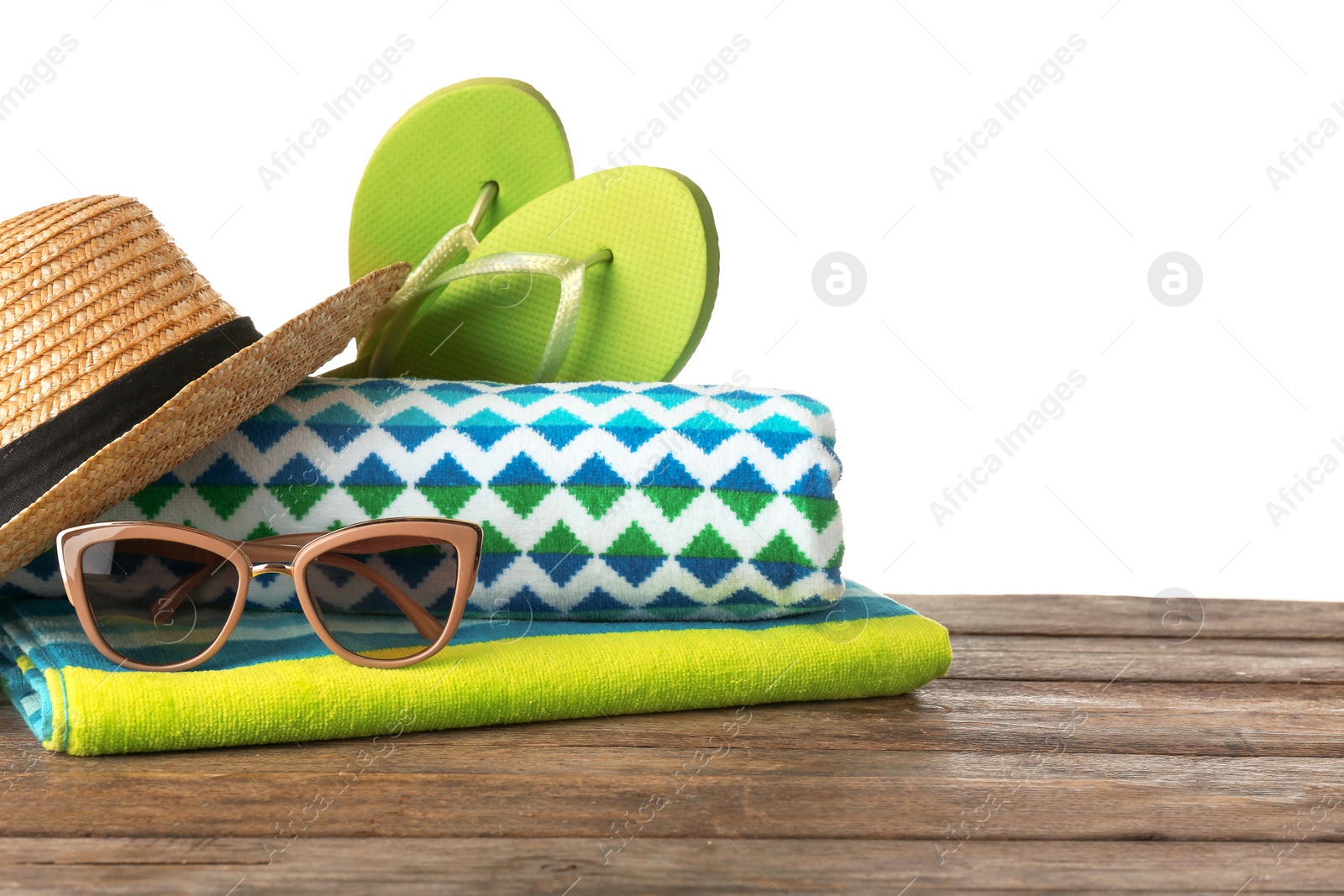 Photo of Set of different beach accessories on table against white background. Space for text