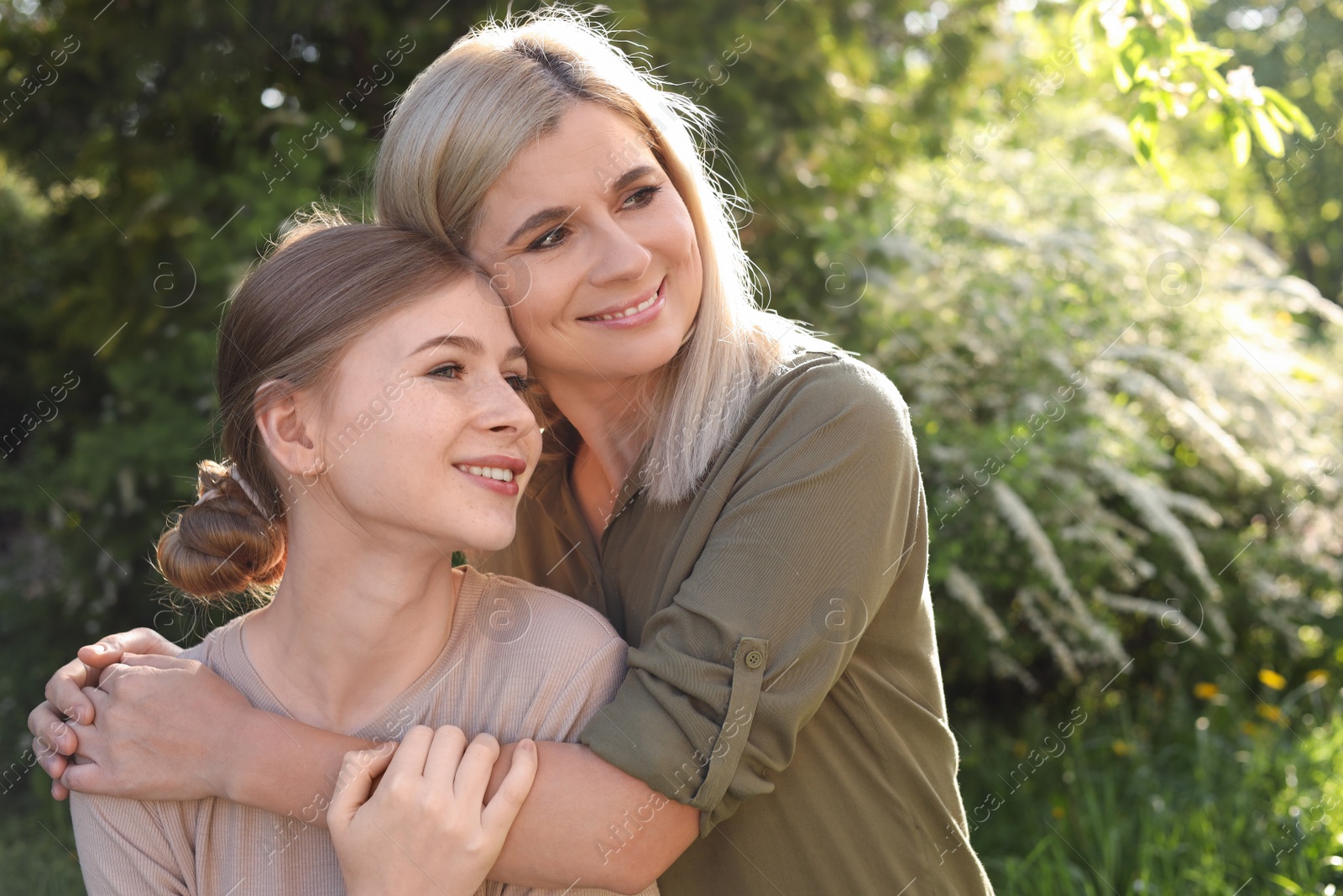 Photo of Happy mother with her daughter spending time together in park on sunny day