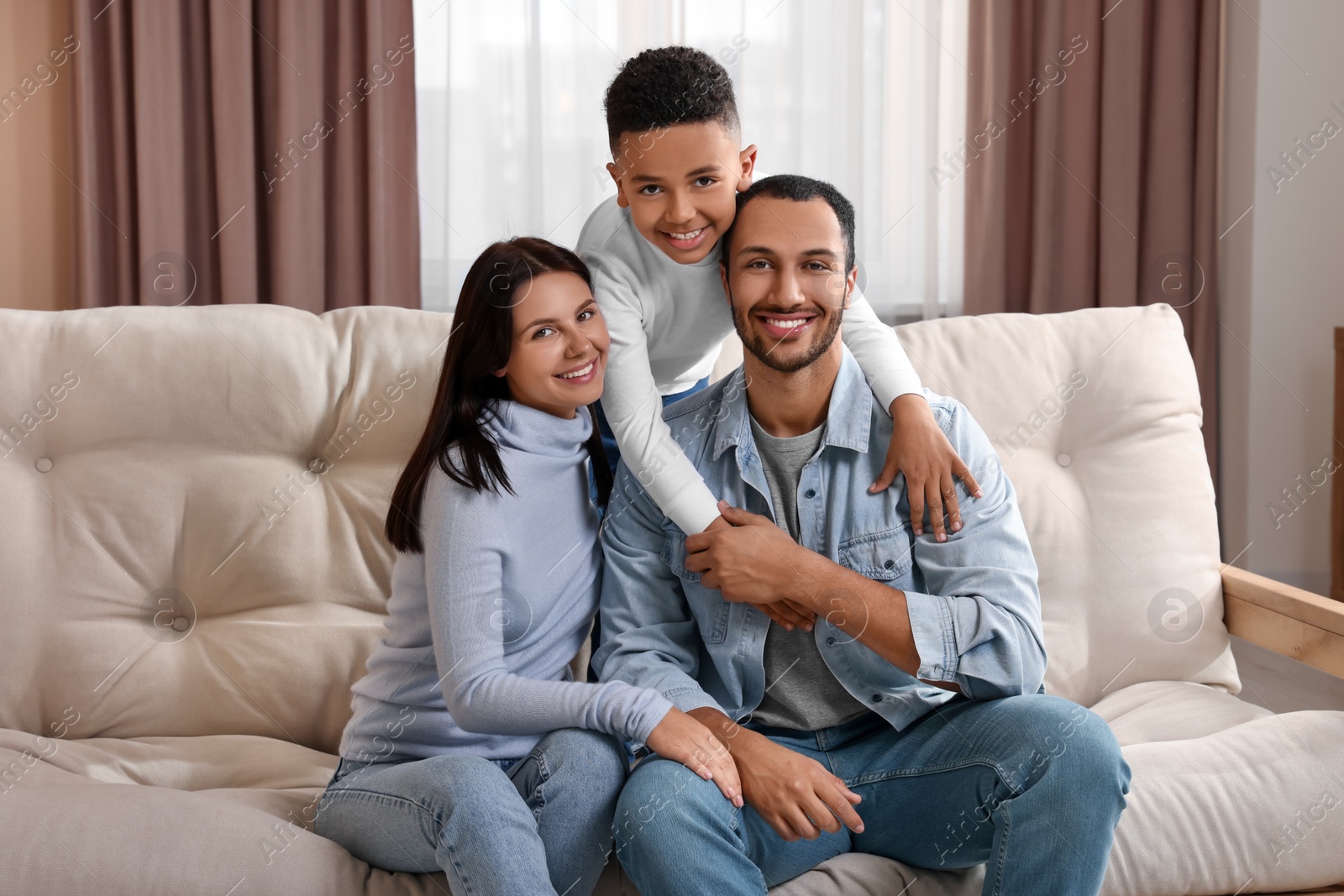 Photo of Happy international family on sofa at home