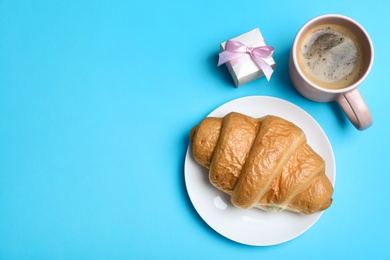 Photo of Romantic breakfast on turquoise background, flat lay with space for text. Valentine's day celebration