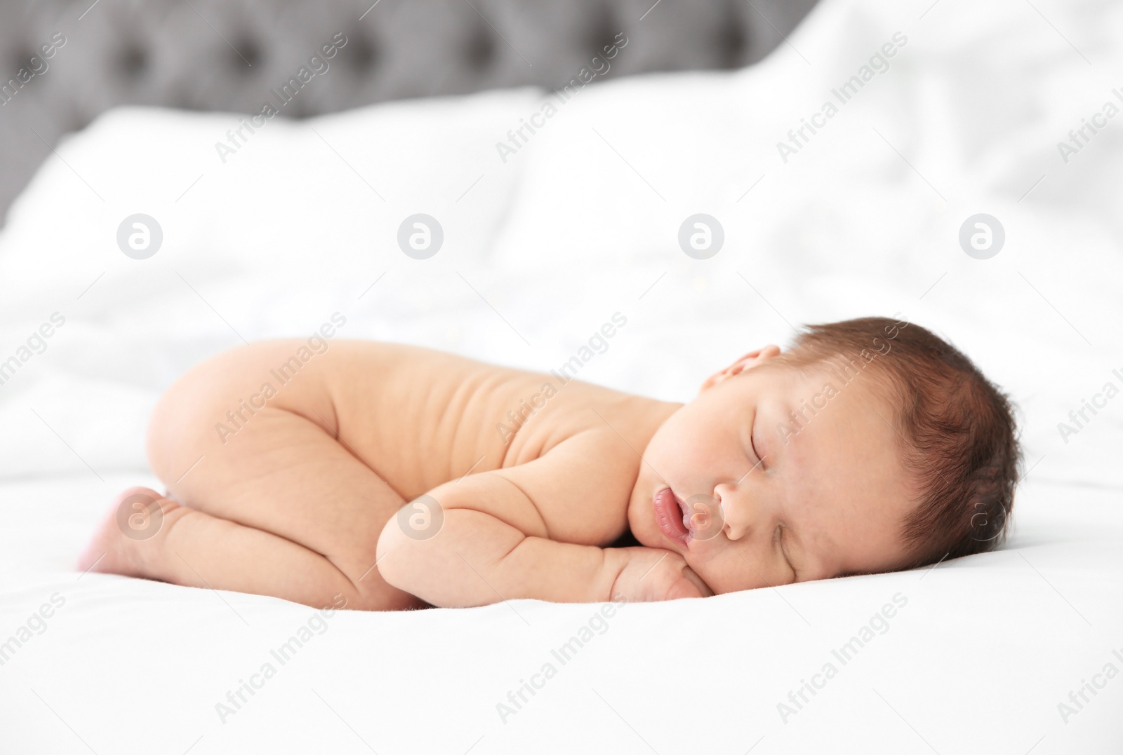 Photo of Adorable newborn baby sleeping on bed