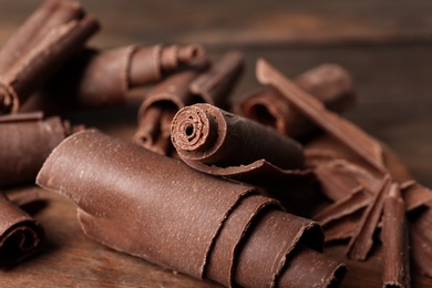 Photo of Chocolate curls for decor on table, closeup