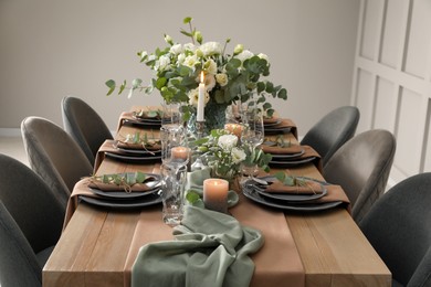 Festive table setting with beautiful floral decor indoors