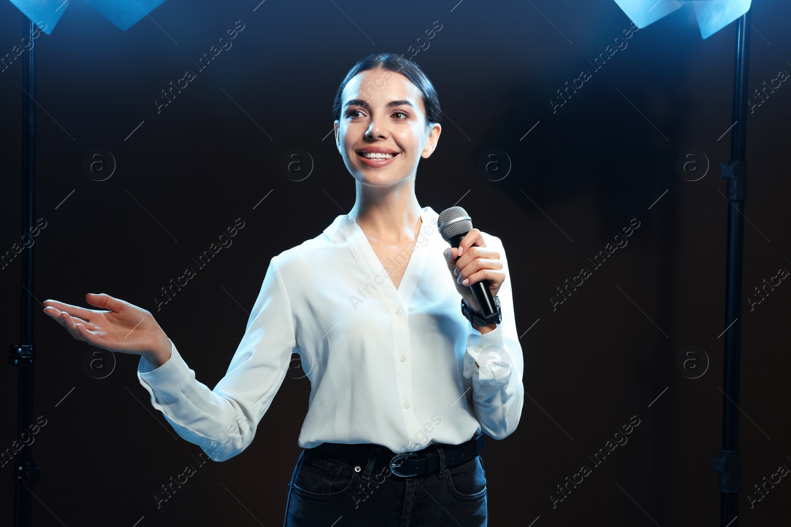 Photo of Motivational speaker with microphone performing on stage