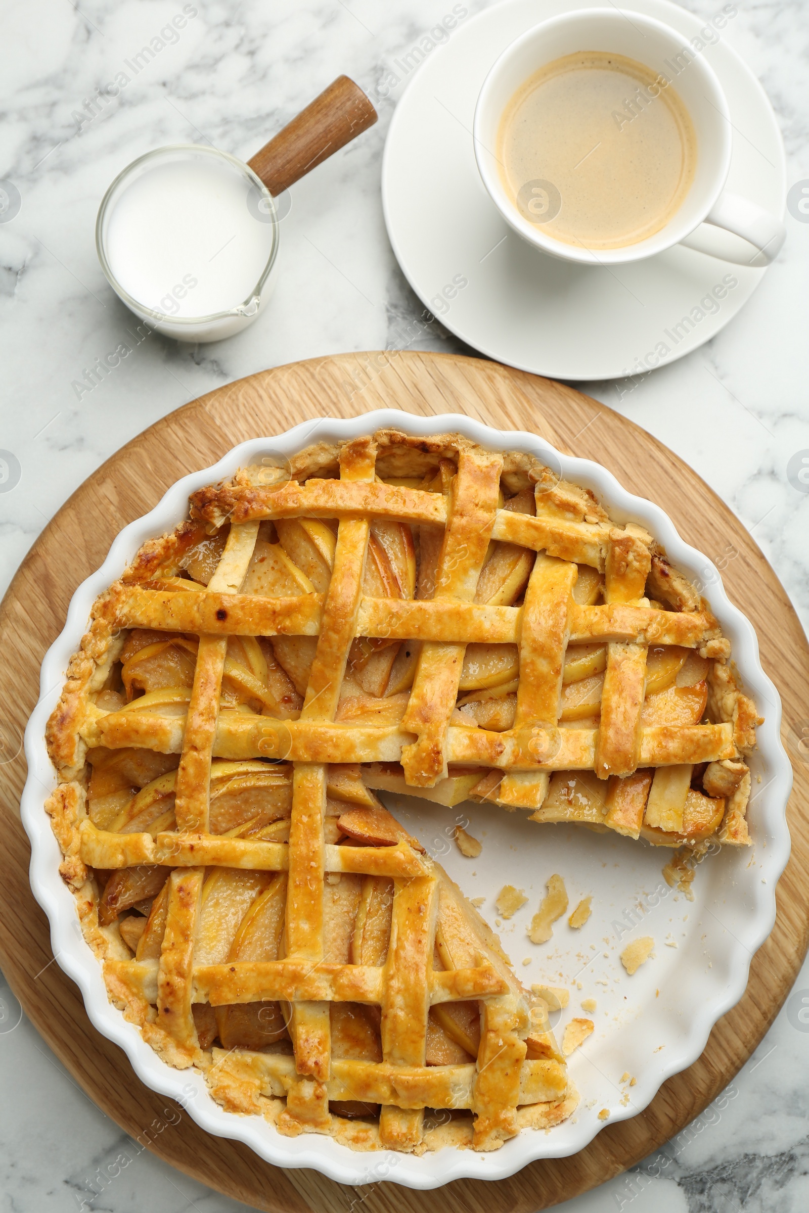 Photo of Tasty homemade quince pie served on white marble table, flat lay
