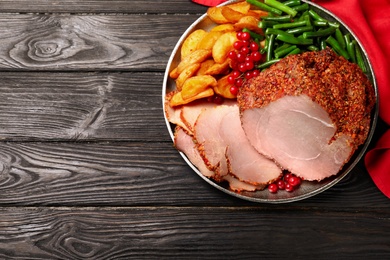 Photo of Plate with delicious ham and potatoes on grey wooden table, top view. Space for text