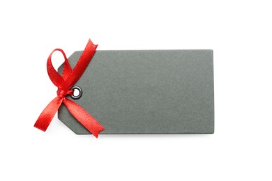 Blank grey gift tag with red satin ribbon on white background, top view. Space for design