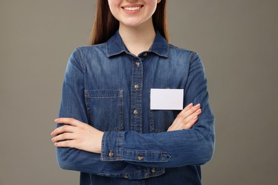 Photo of Woman with blank badge on grey background, closeup