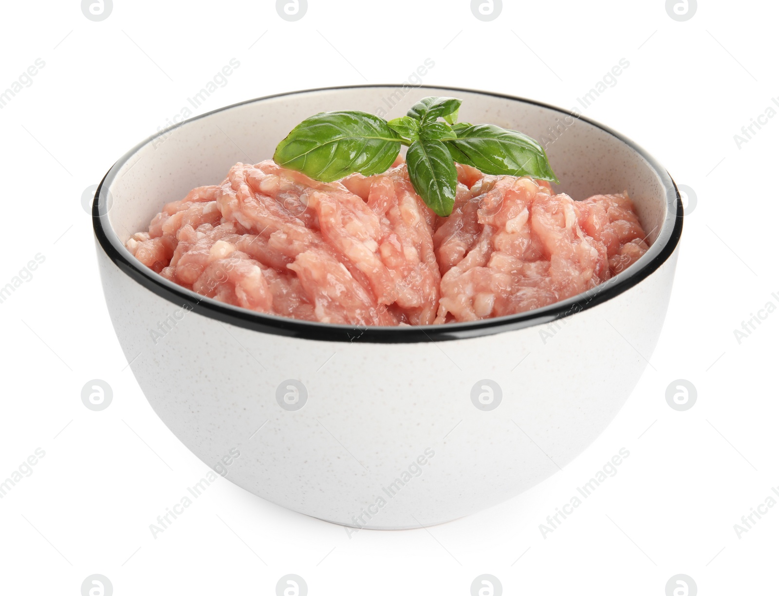 Photo of Raw chicken minced meat with basil in bowl on white background