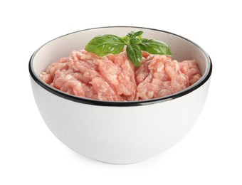 Photo of Raw chicken minced meat with basil in bowl on white background
