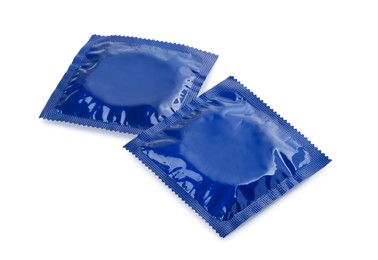 Packaged condoms on white background. Safe sex
