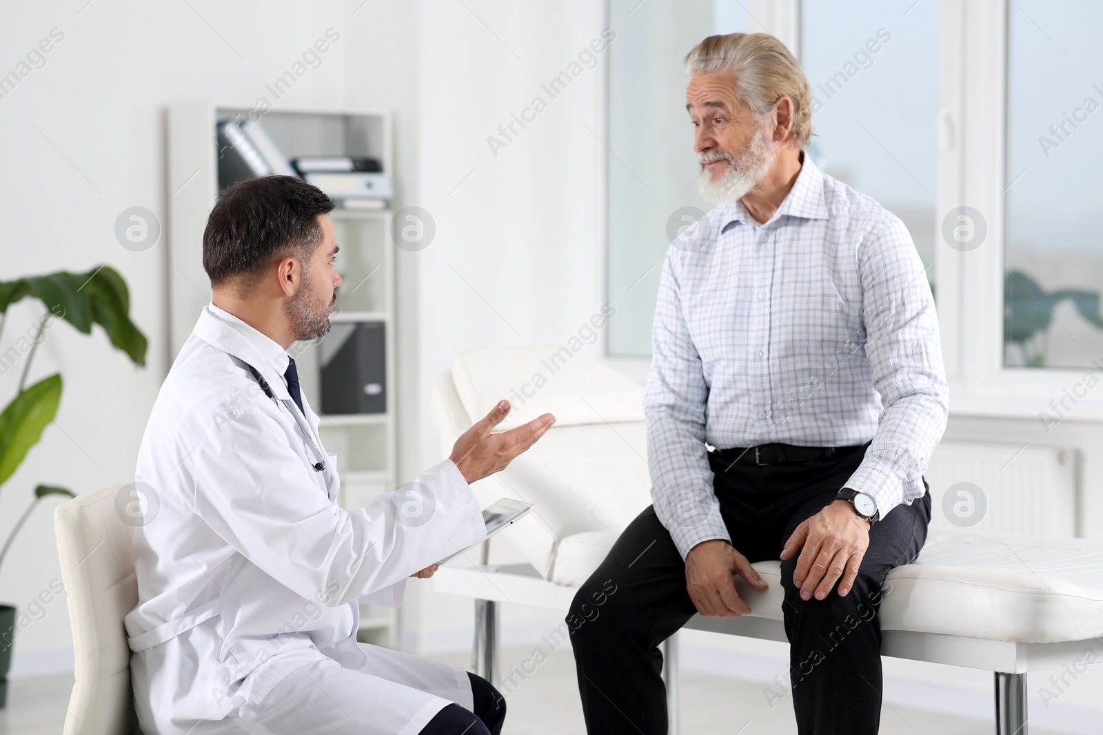 Photo of Senior patient having appointment with doctor in clinic