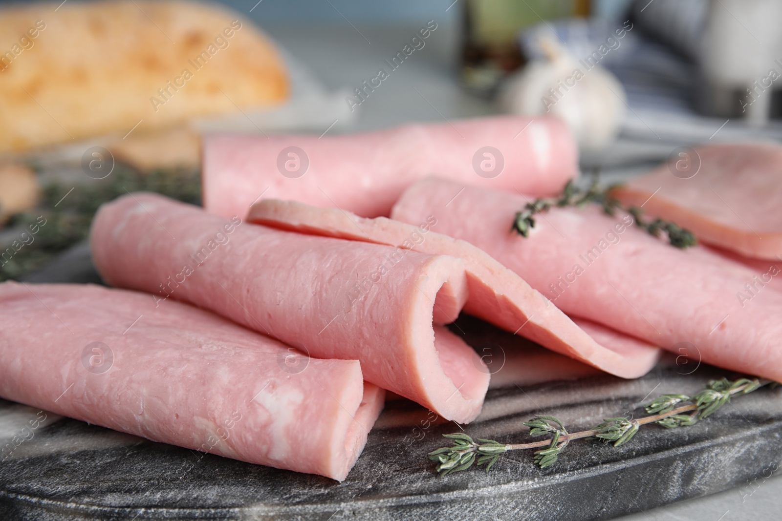 Photo of Tasty ham on light grey table, closeup