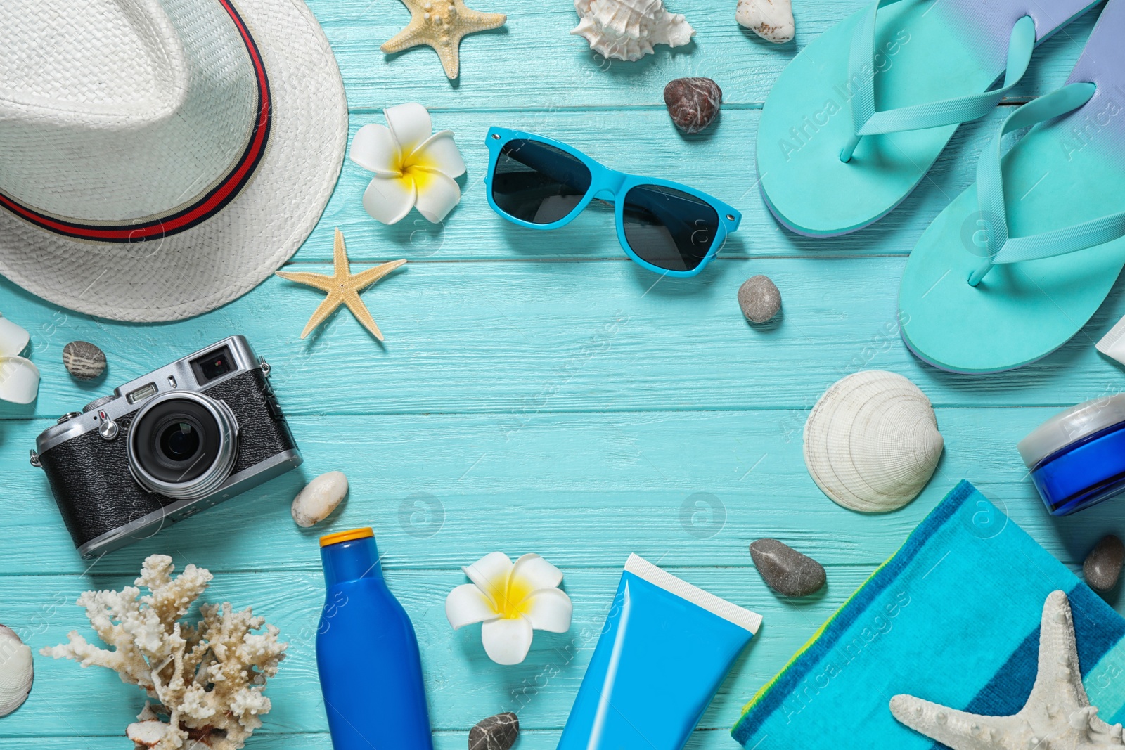 Photo of Flat lay composition with stylish beach accessories on light blue wooden background, space for text